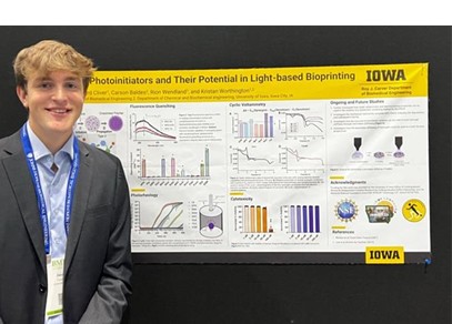 Jacob Cannon poses with his research poster