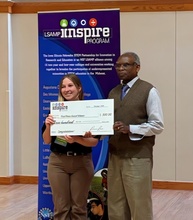 photo of Emily receiving her 1st place award for best presentation